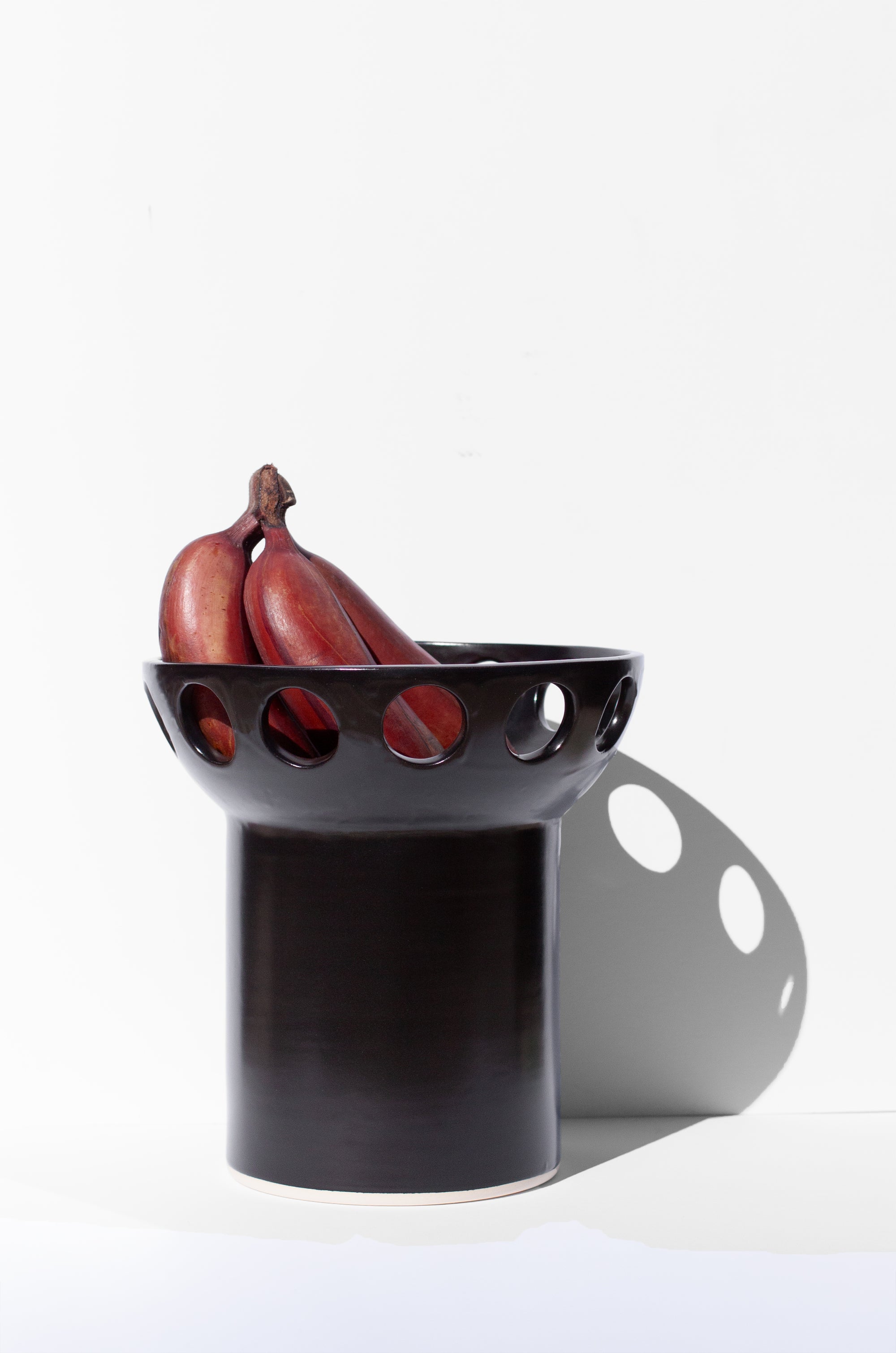 Handmade Black fruit bowl with pedestal base and cutout design