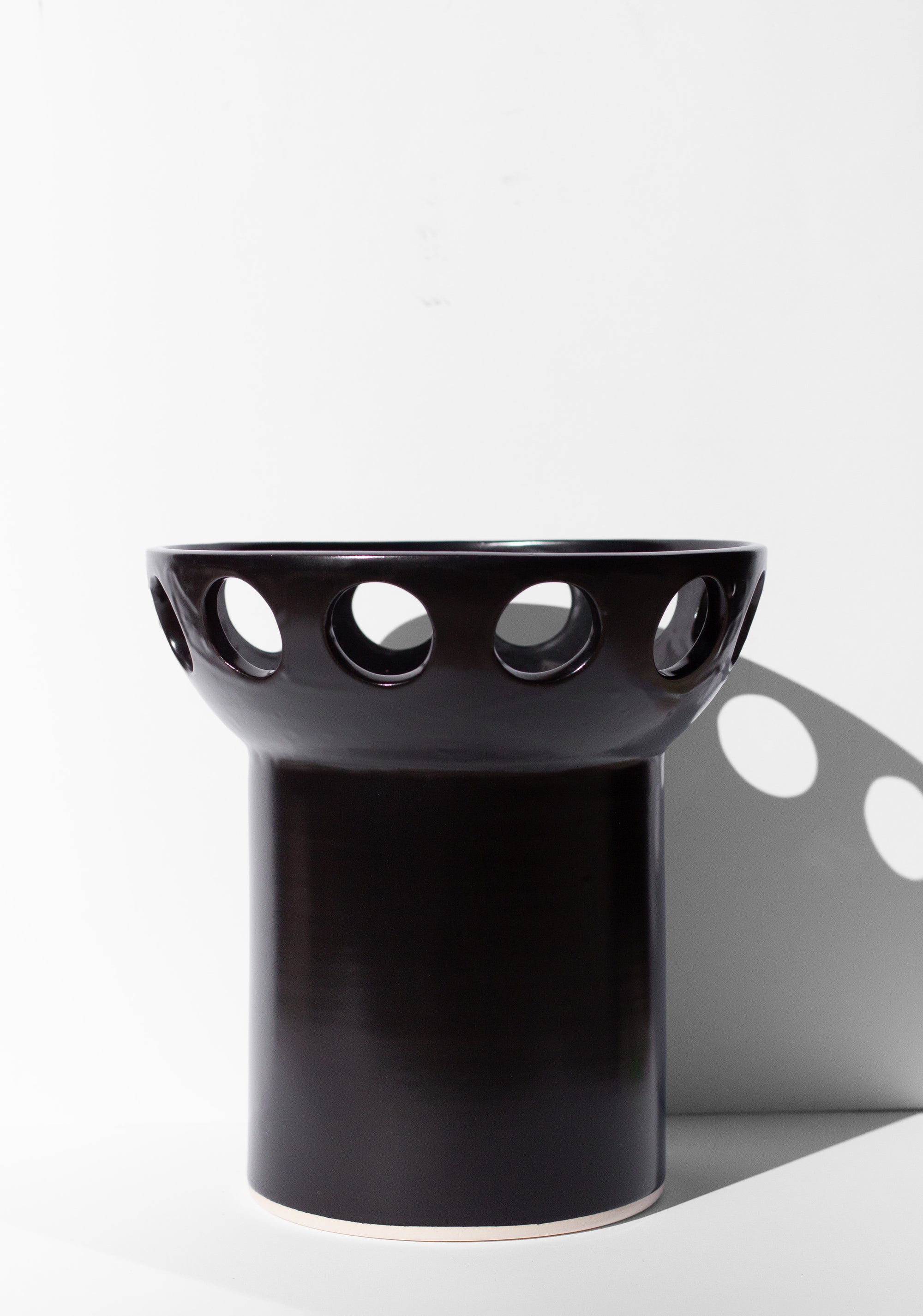 Handmade Black fruit bowl with pedestal base and cutout design