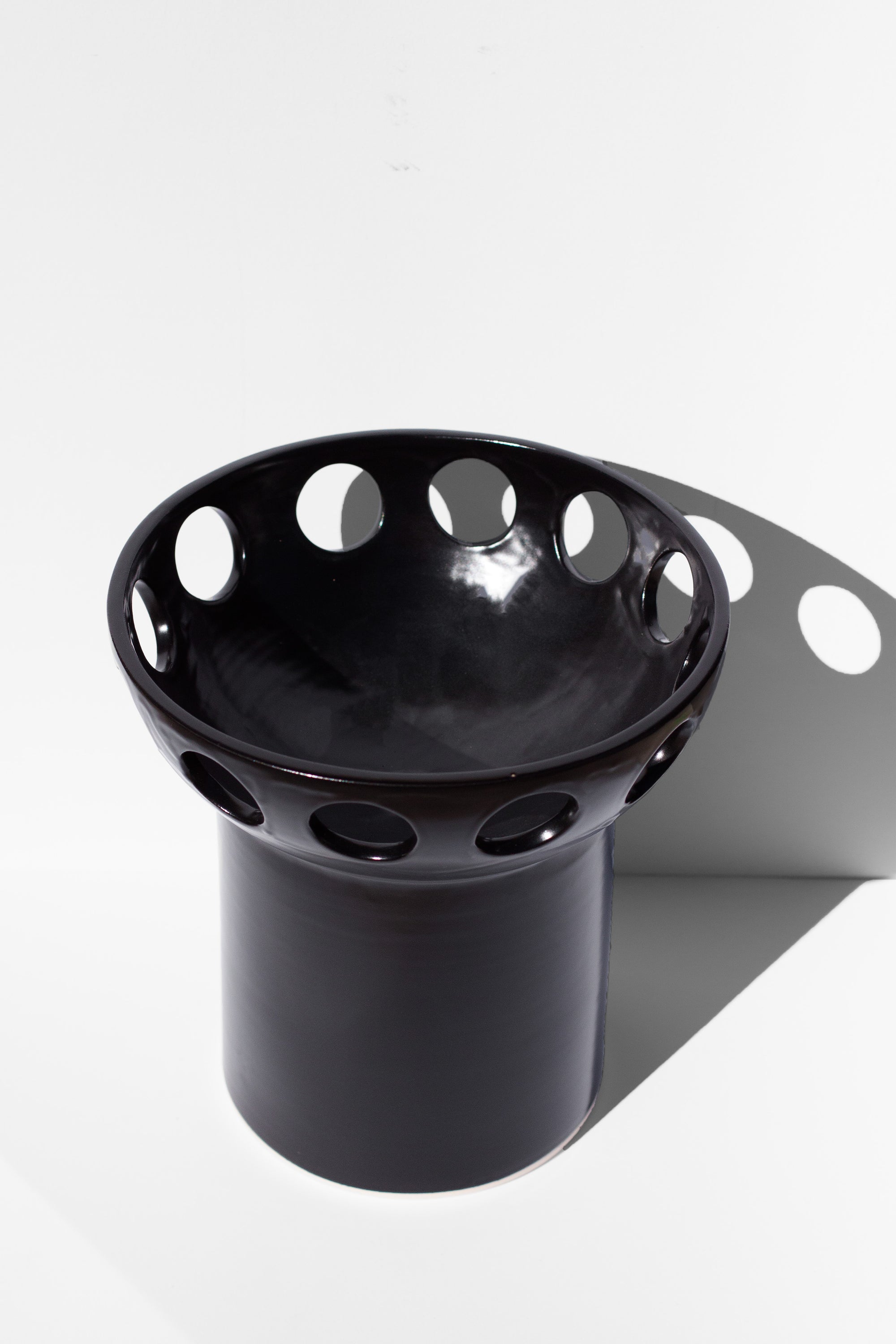 Handmade Black fruit bowl with pedestal base and cutout design