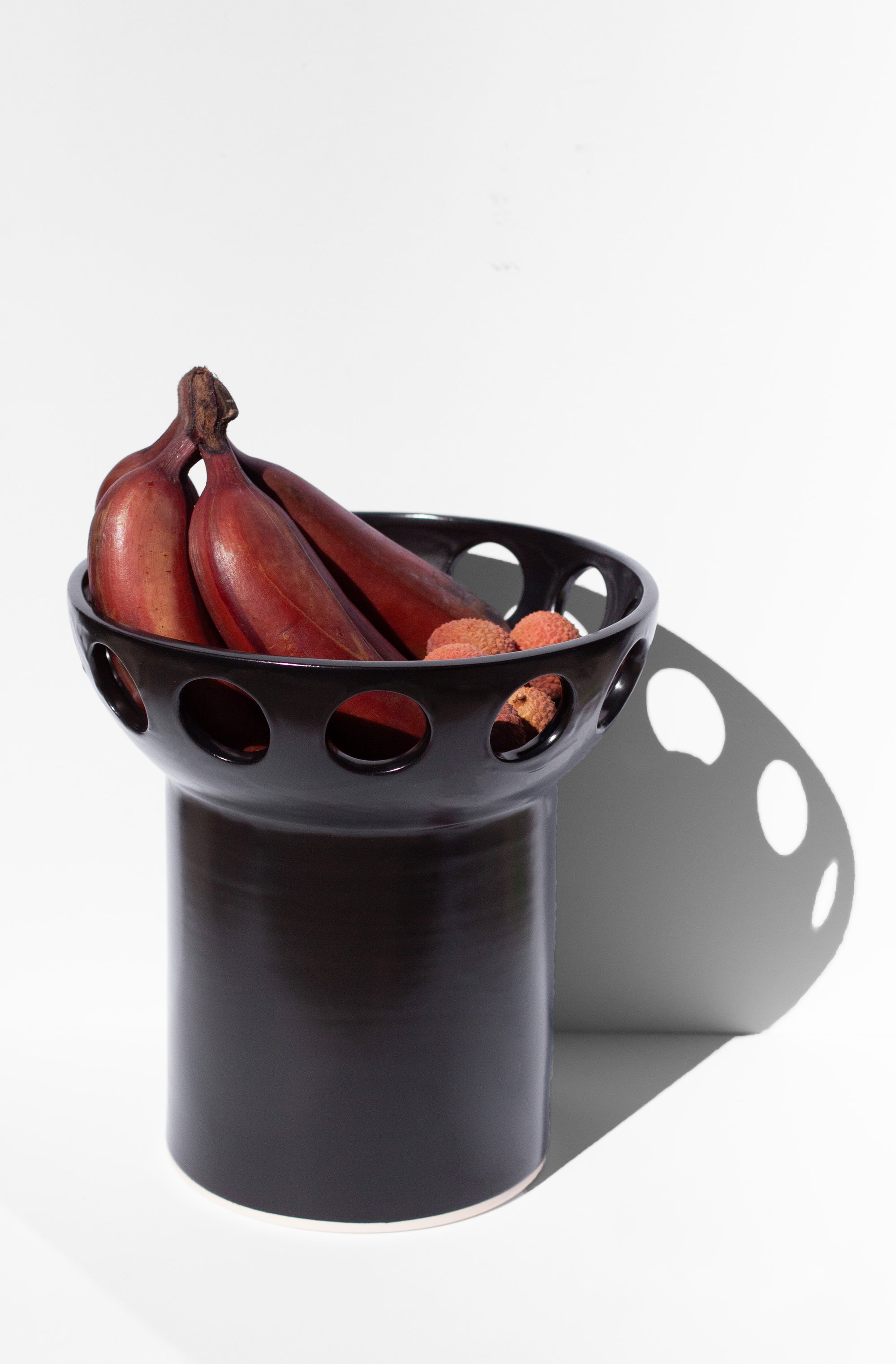 Handmade Black fruit bowl with pedestal base and cutout design