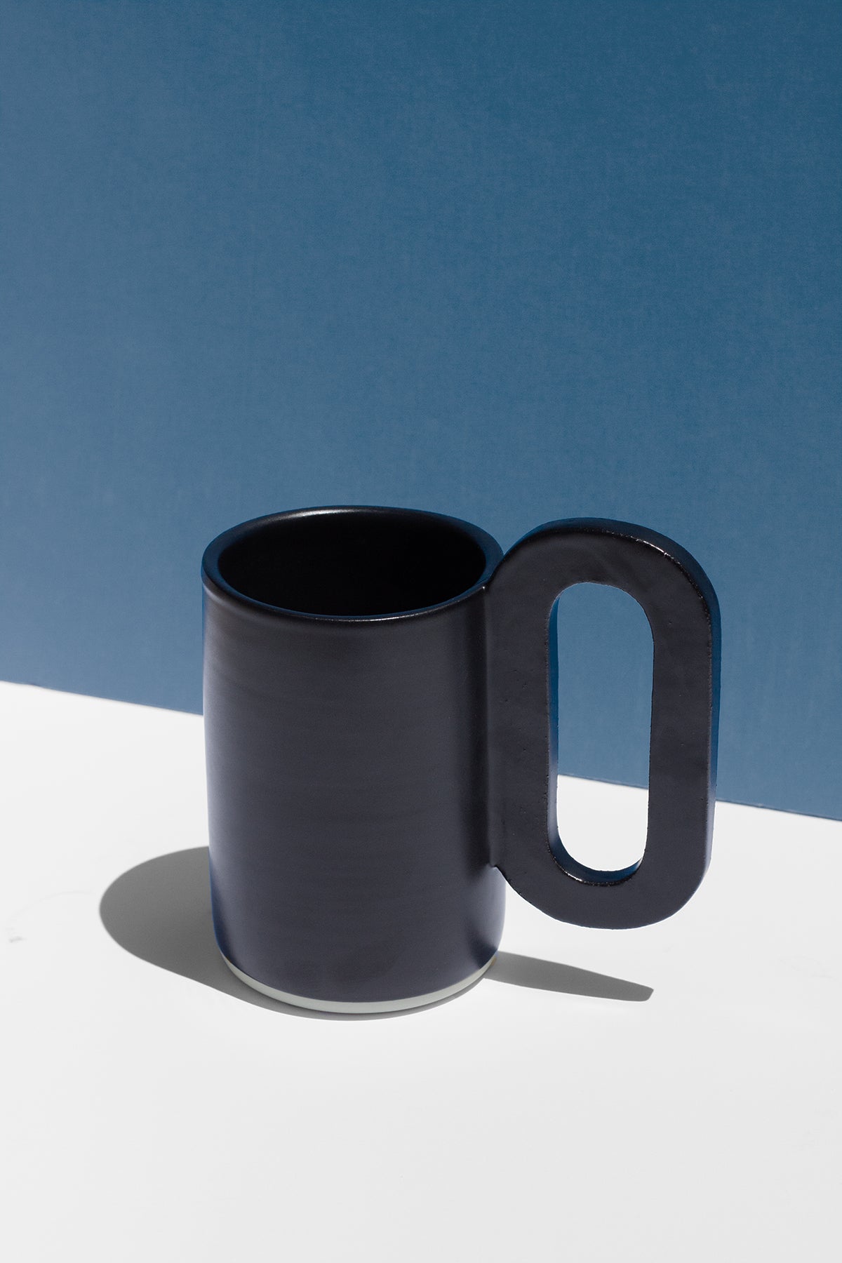 Handmade Tall black mug with loop shaped handle