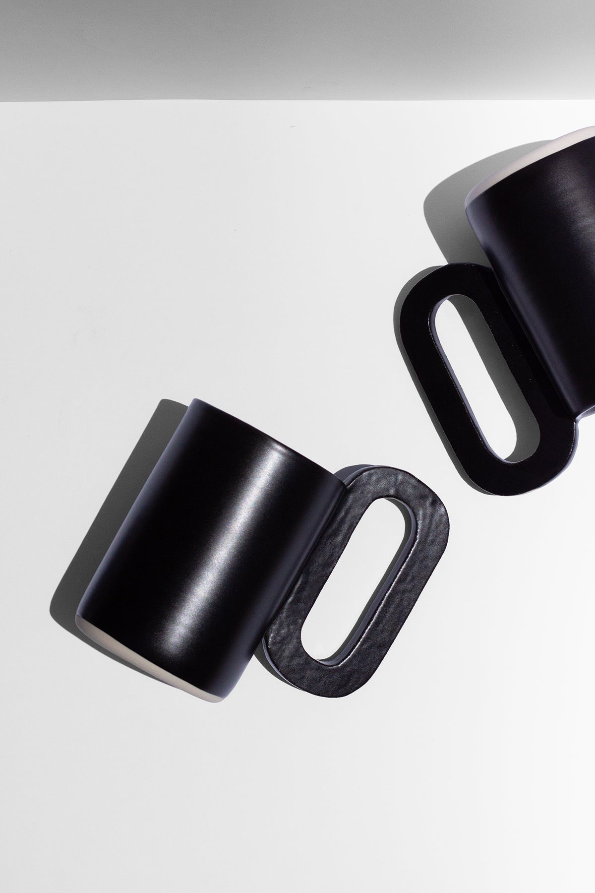 Handmade Tall black mug with loop shaped handle