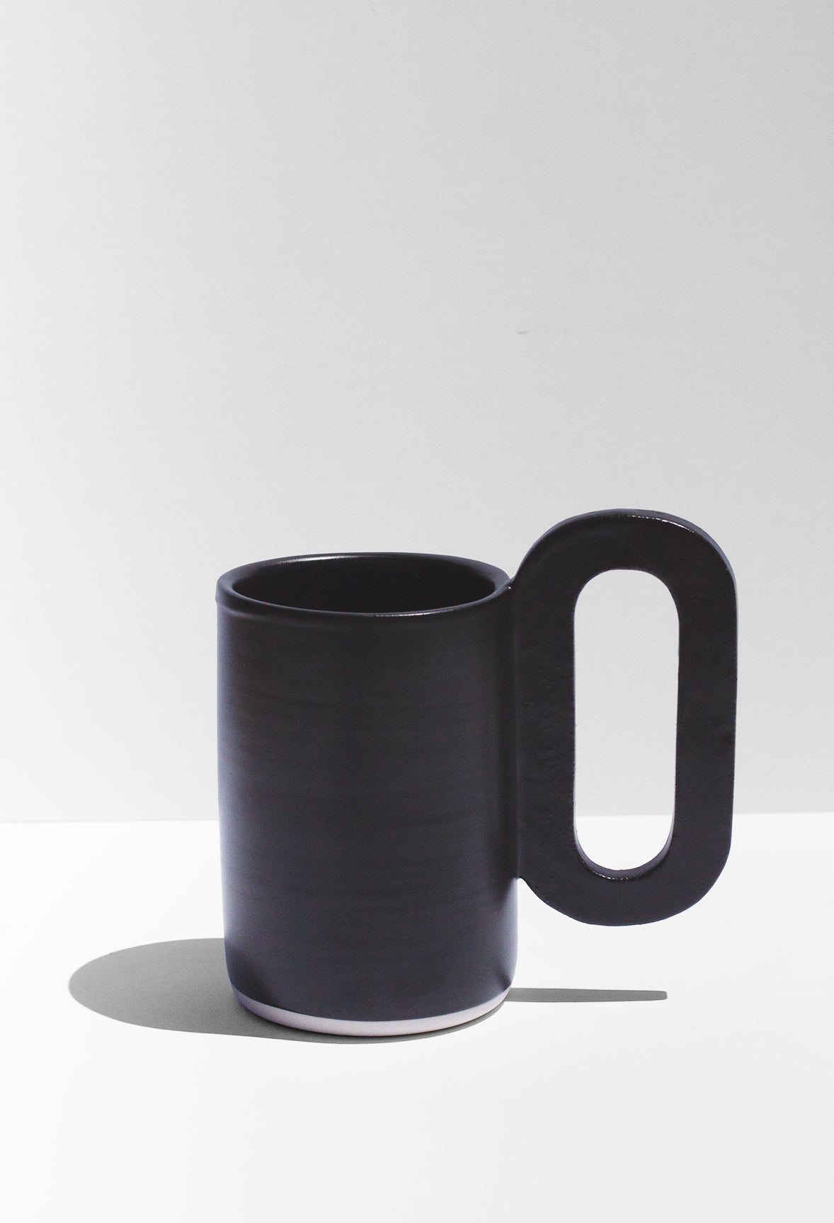  Handmade Tall black mug with loop shaped handle