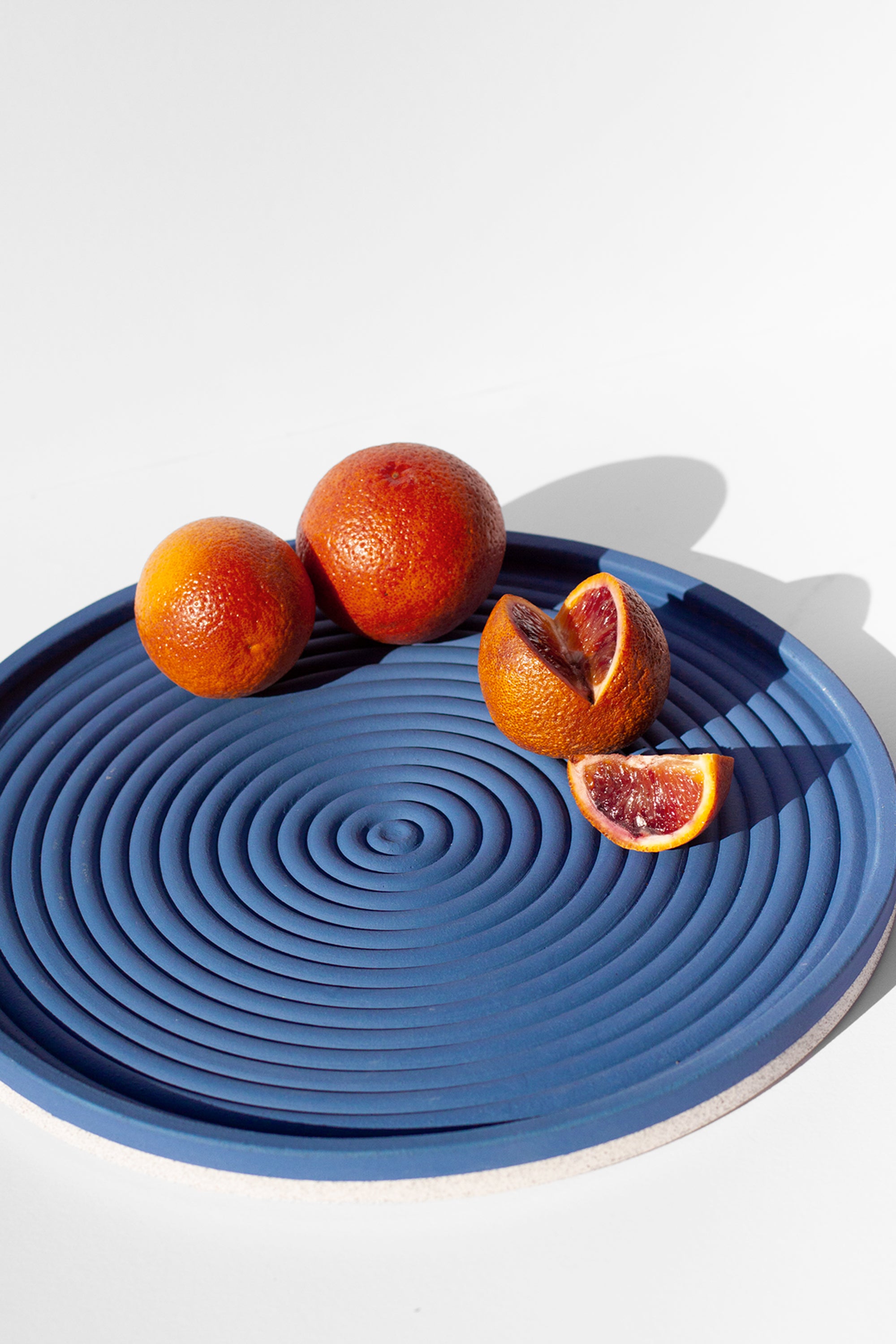 Handmade Cobalt blue serving platter with concentric circle design and speckled finish