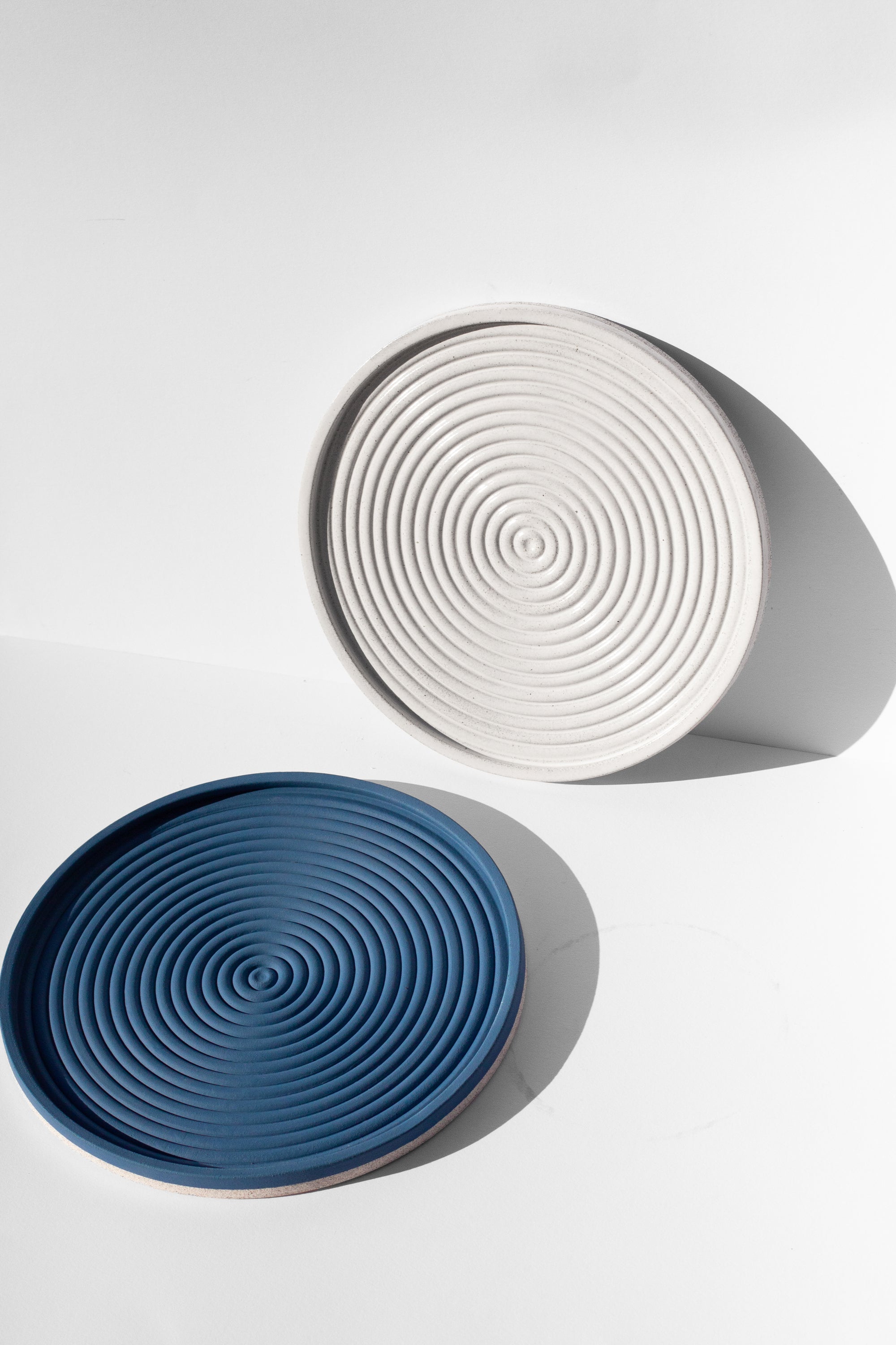 Handmade Cobalt blue and white serving platters with concentric circle design and speckled finish