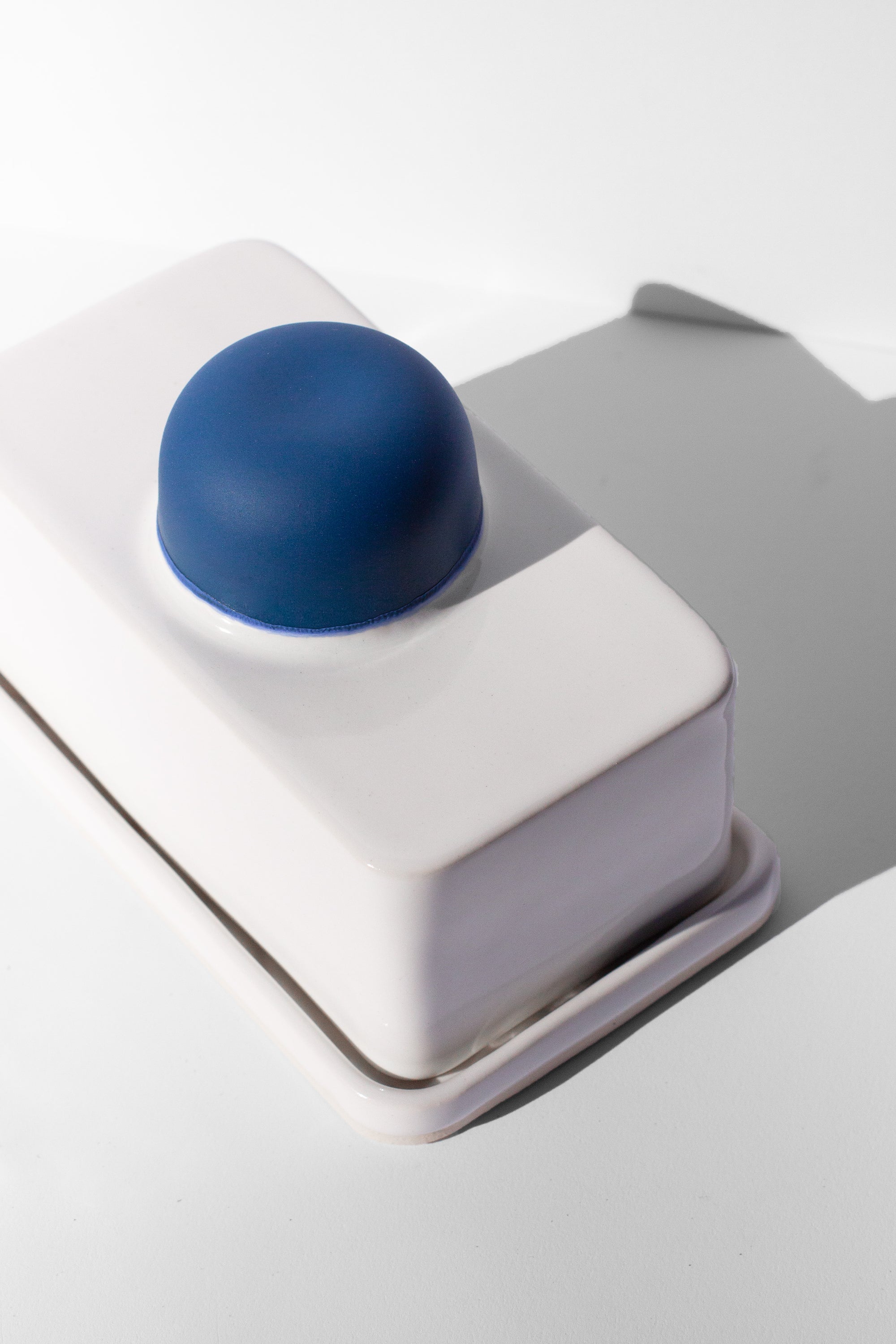 Handmade white and cobalt blue butter dish with cobalt blue knob handle.