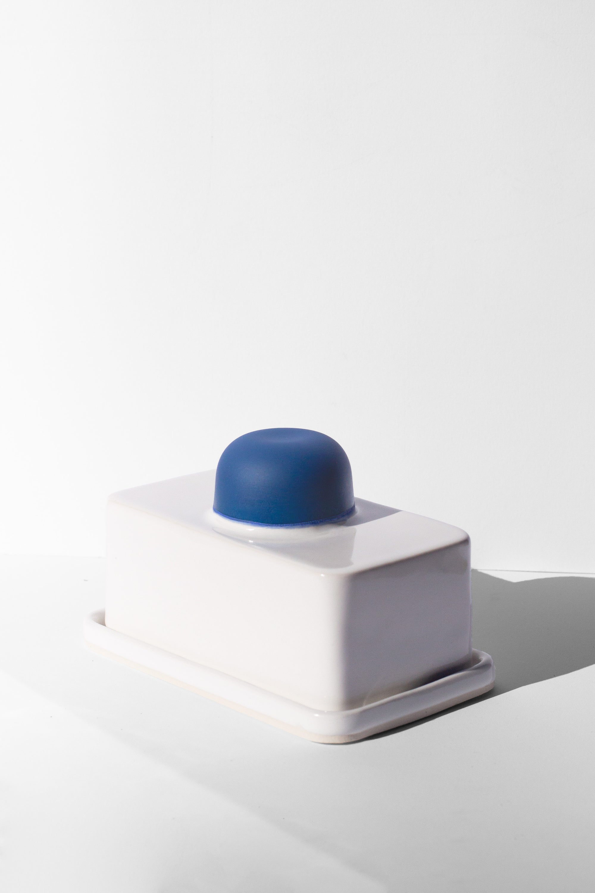 Handmade white and cobalt blue butter dish with cobalt blue knob handle.