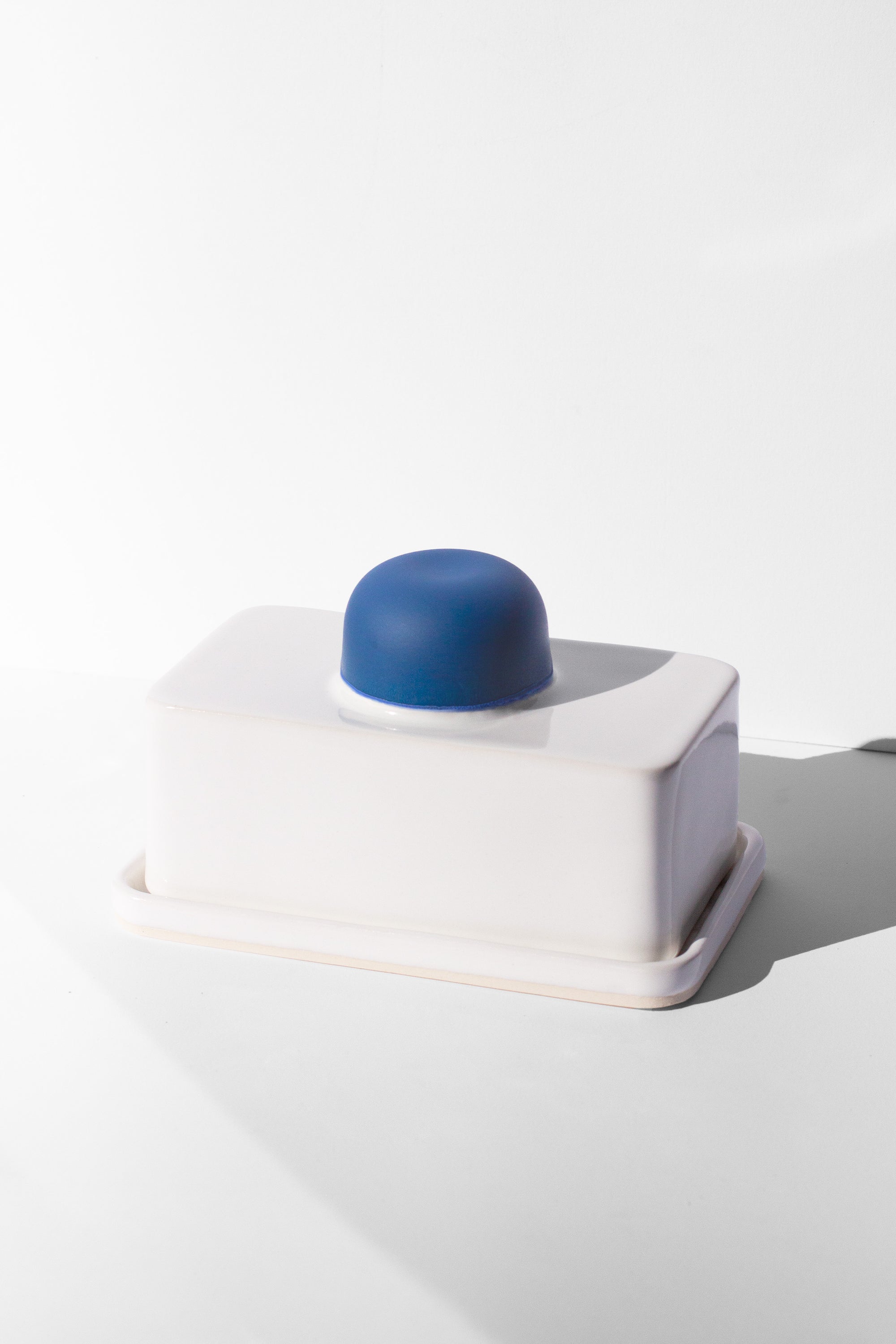 Handmade white and cobalt blue butter dish with cobalt blue knob handle.