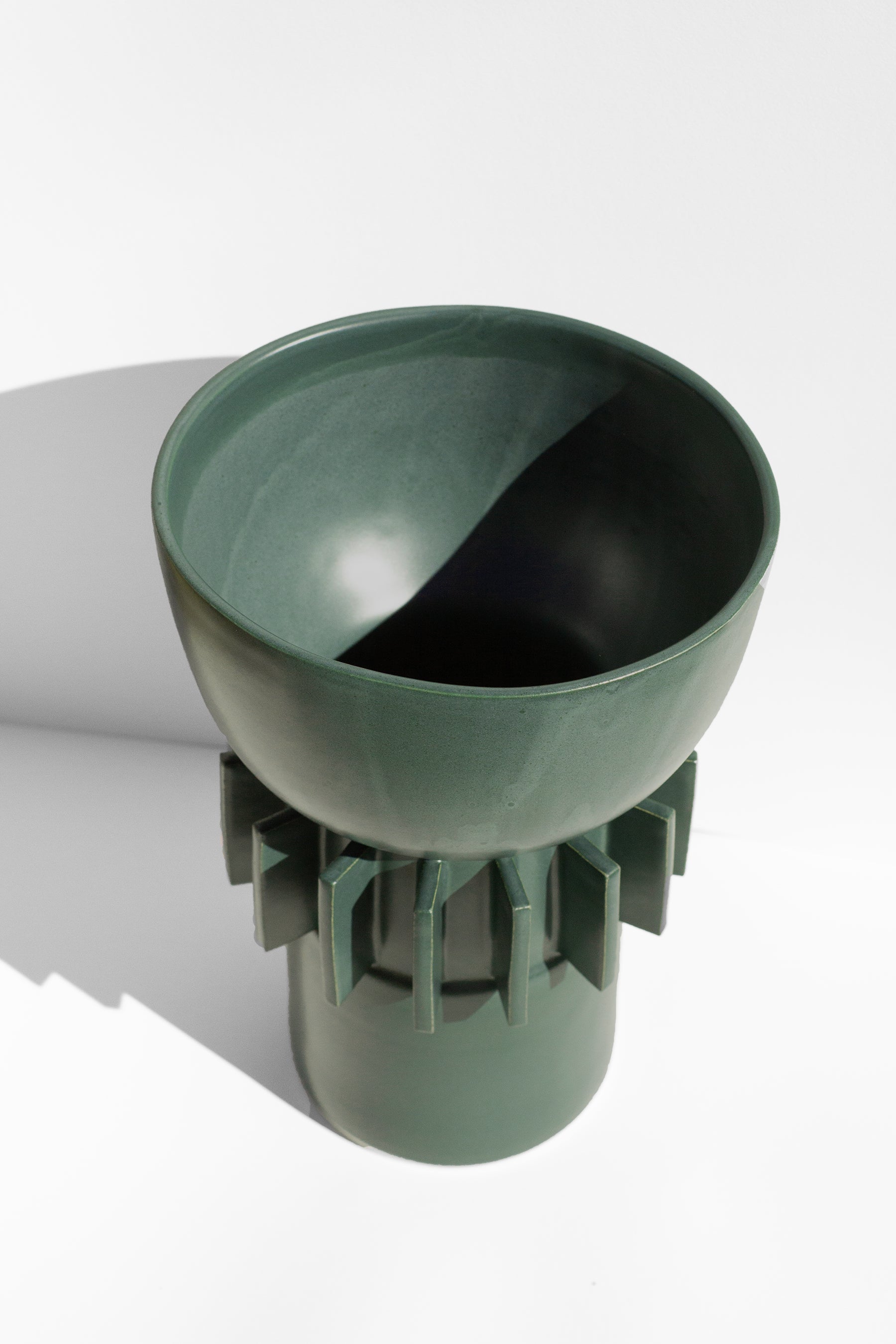 Handmade Tall green vase with rounded top and flange design around the outside.