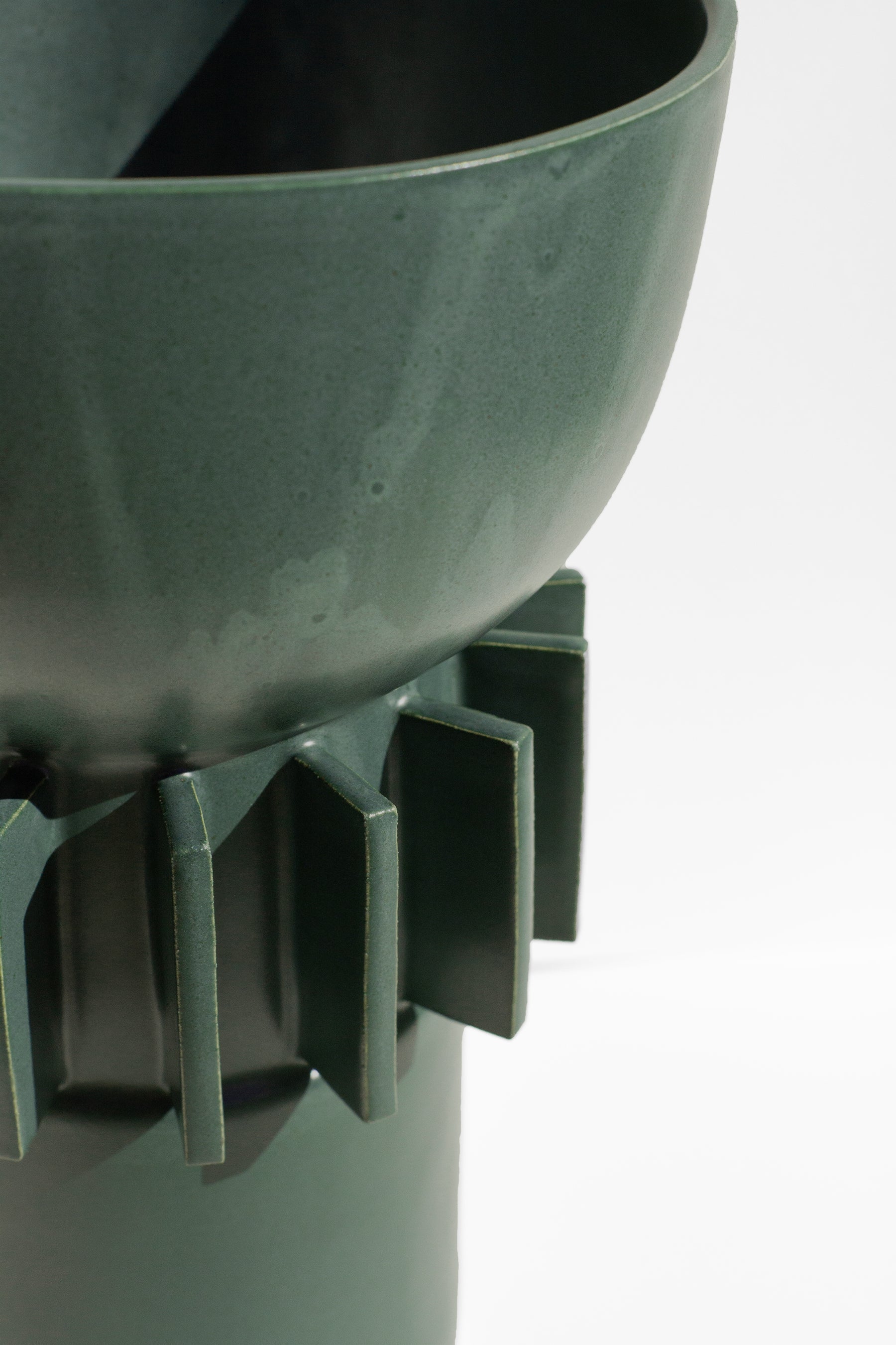 Handmade Tall green vase with rounded top and flange design around the outside.