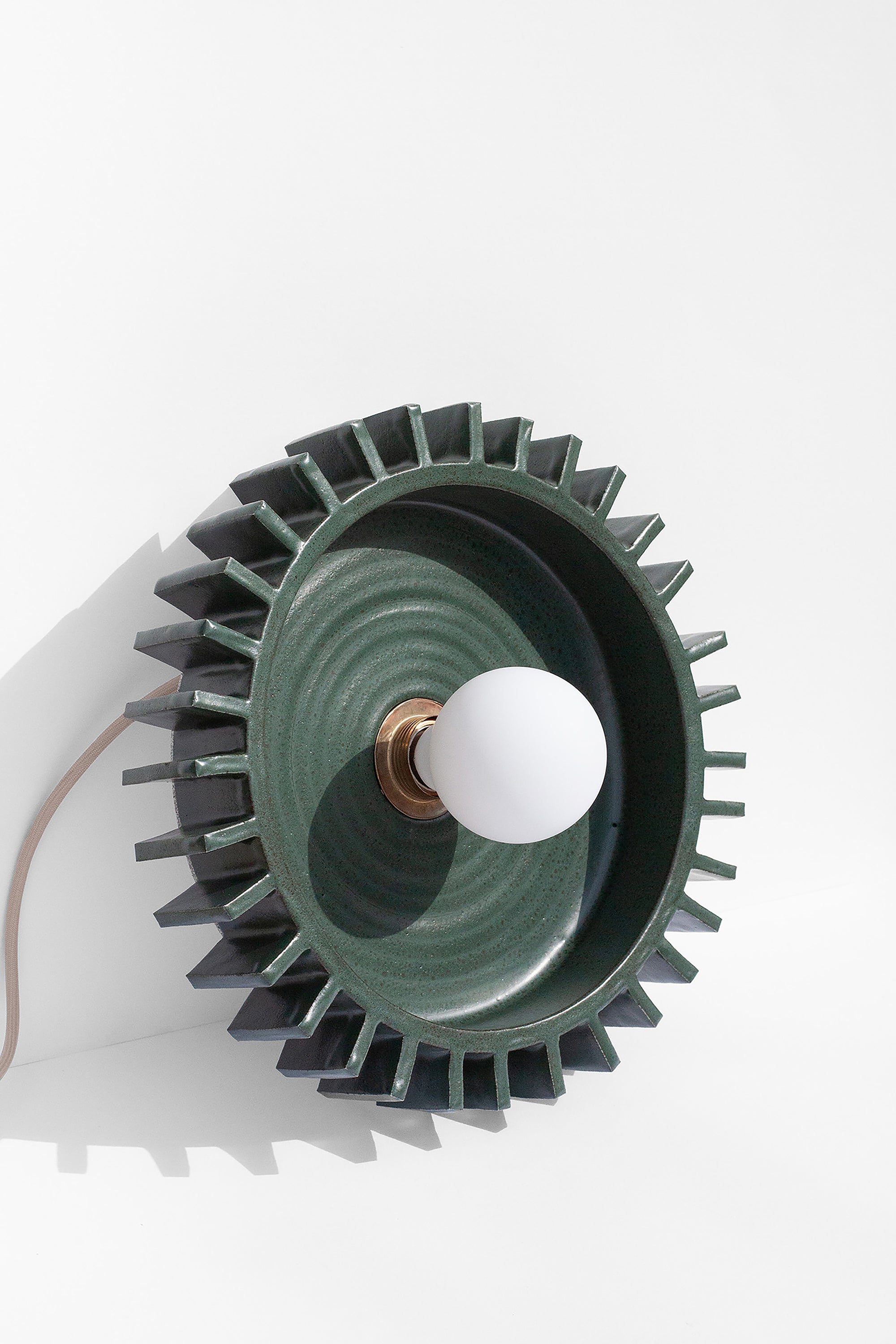 Handmade Green pendant light fixture with geometric flange design on outside edge