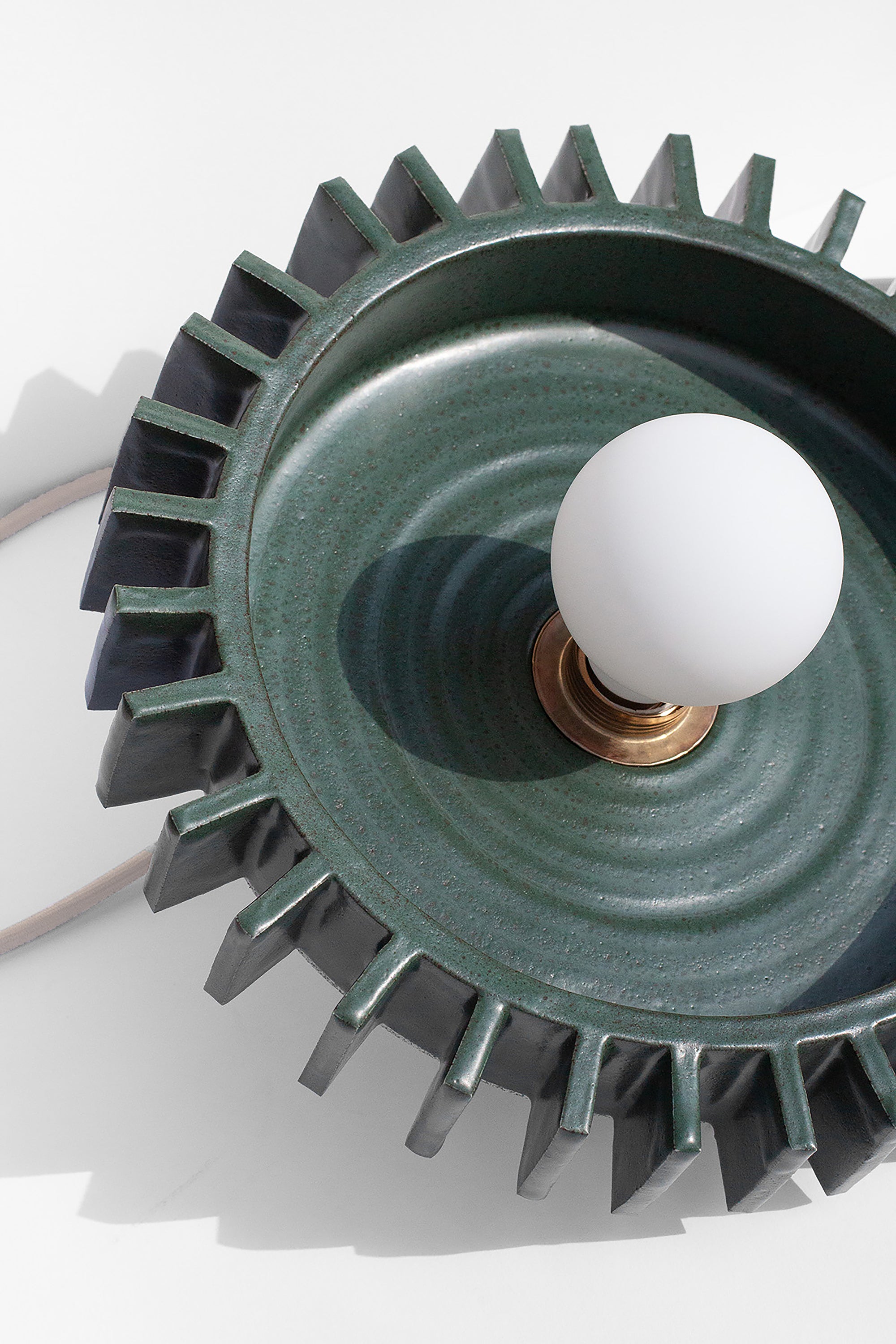 Handmade Green pendant light fixture with geometric flange design on outside edge