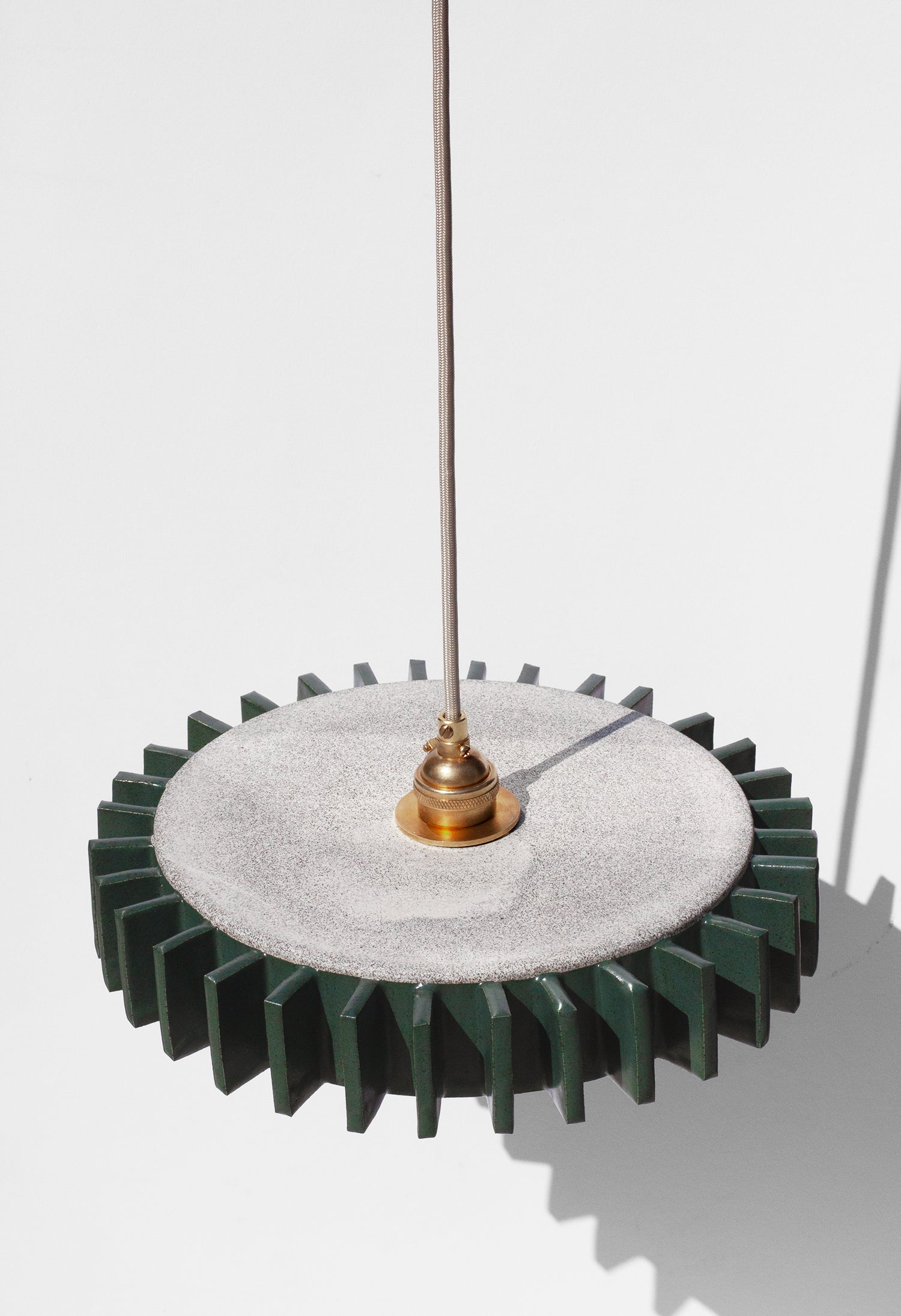 Handmade Green pendant light fixture with geometric flange design on outside edge