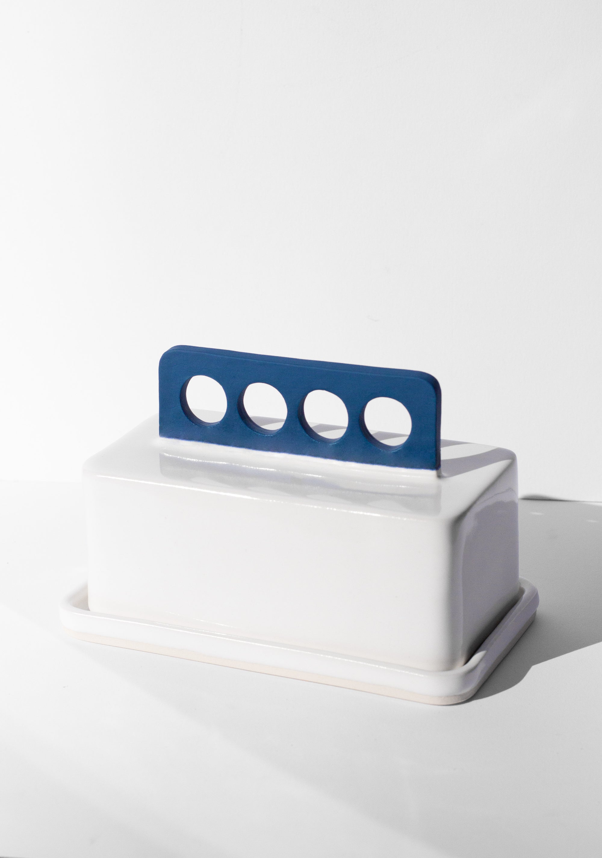 Handmade white and cobalt blue butter dish with cobalt blue handle with cutout design 