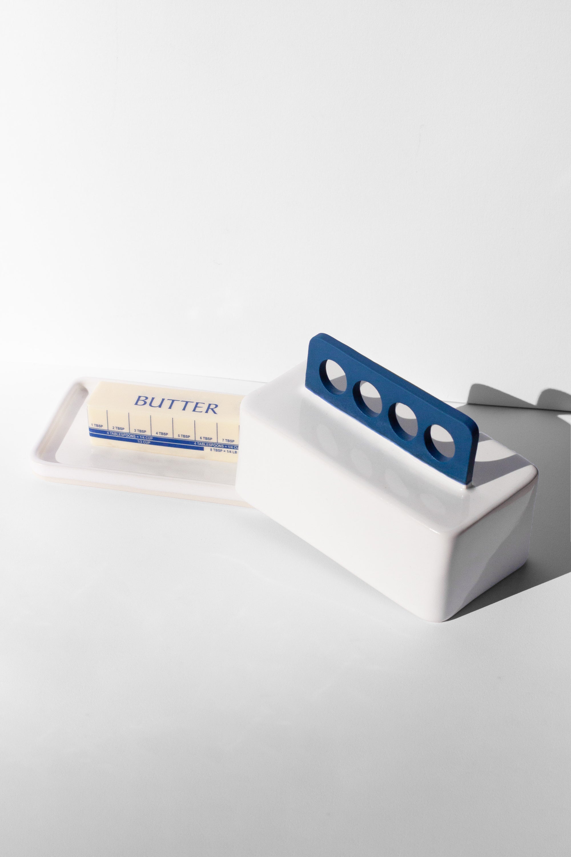 Handmade white and cobalt blue butter dish with cobalt blue handle with cutout design 