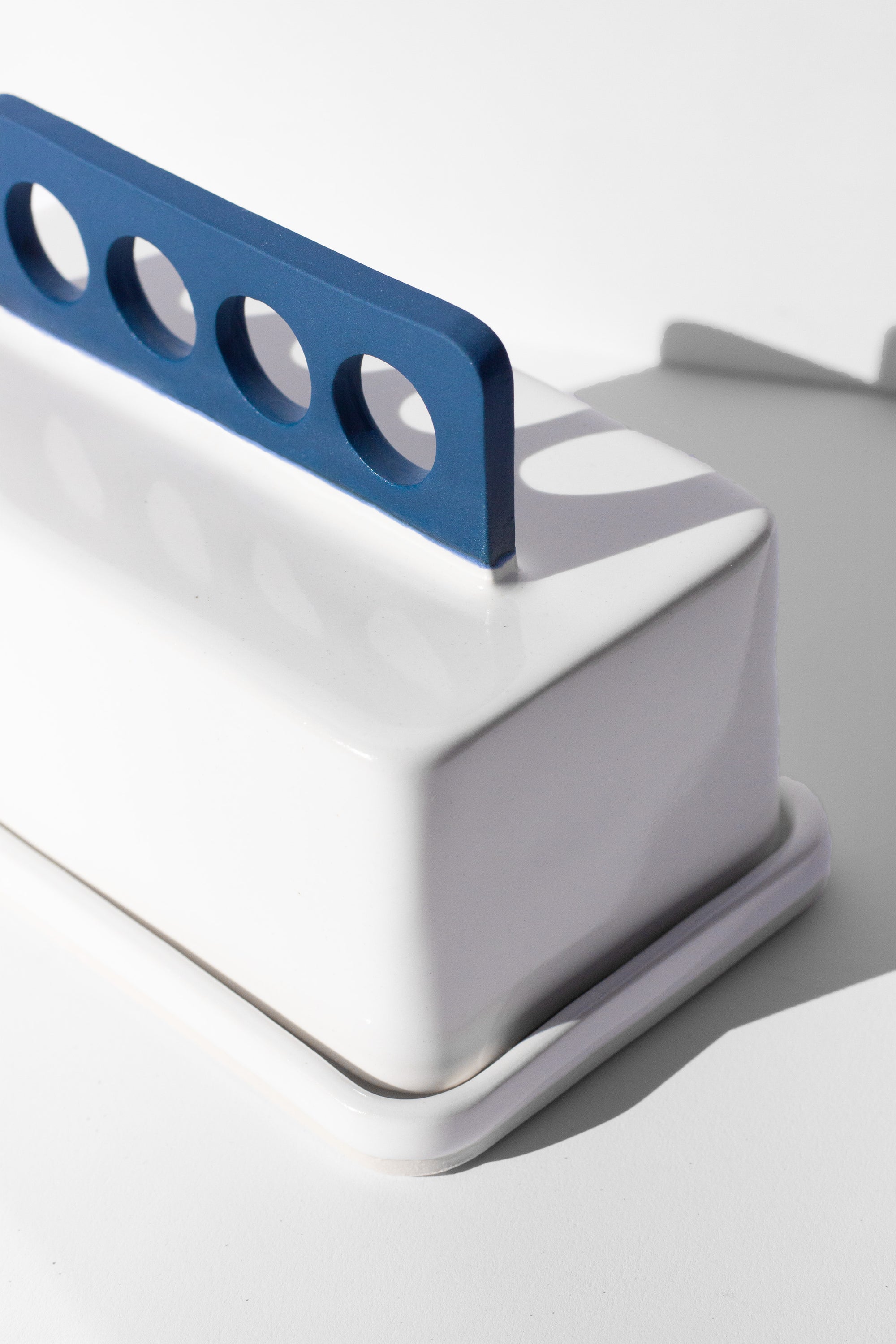 Handmade white and cobalt blue butter dish with cobalt blue handle with cutout design 