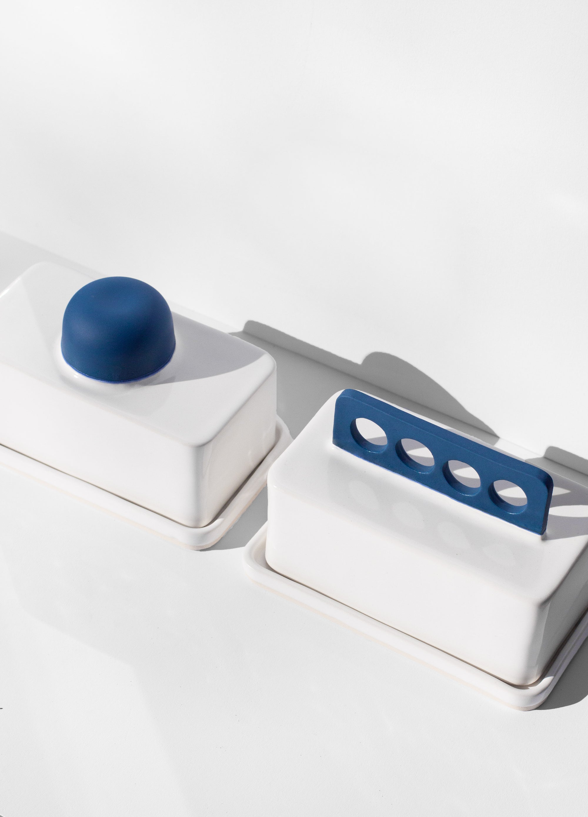 Handmade white and cobalt blue butter dish with cobalt blue handle with cutout design 
