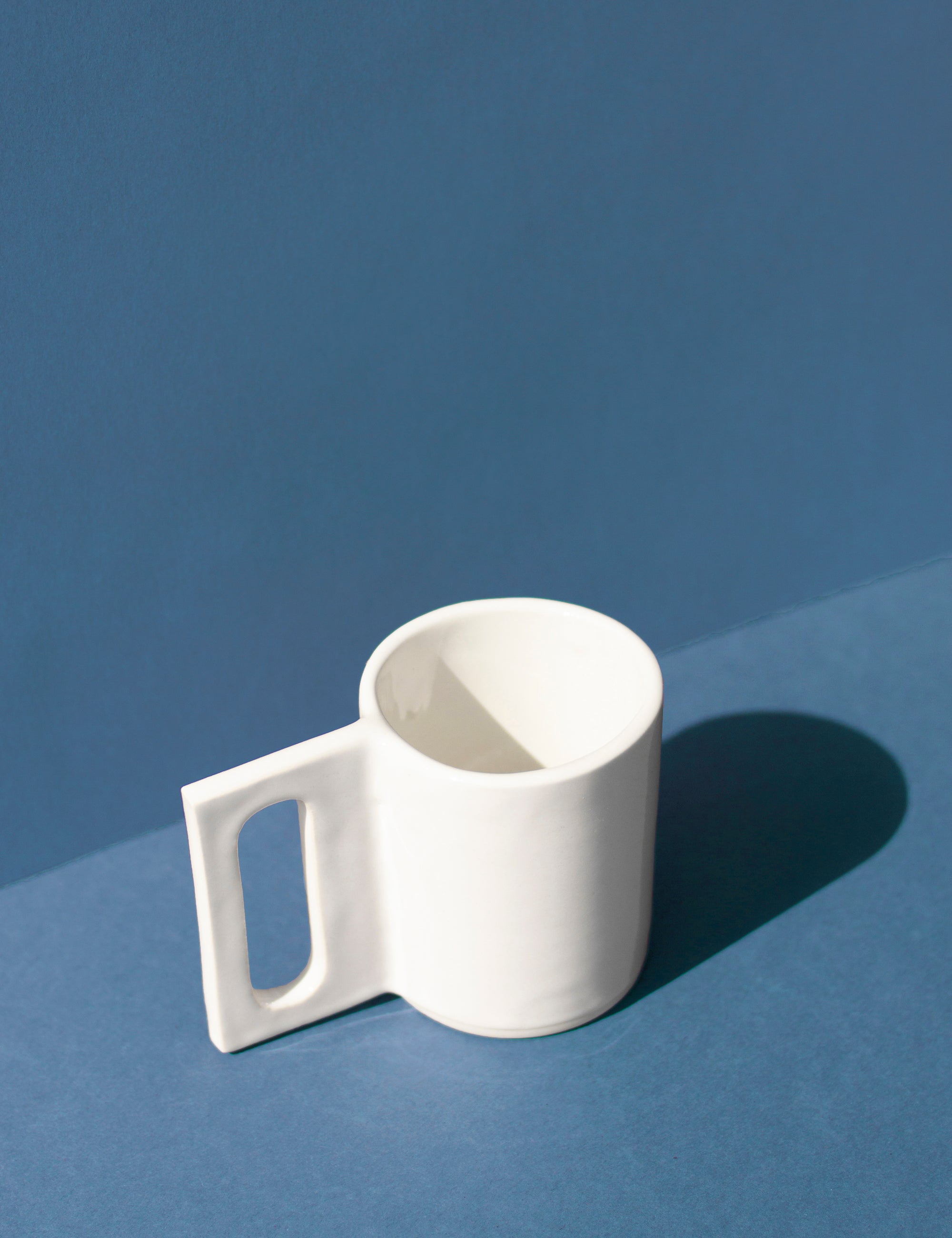Handmade White mug with a geometric handle