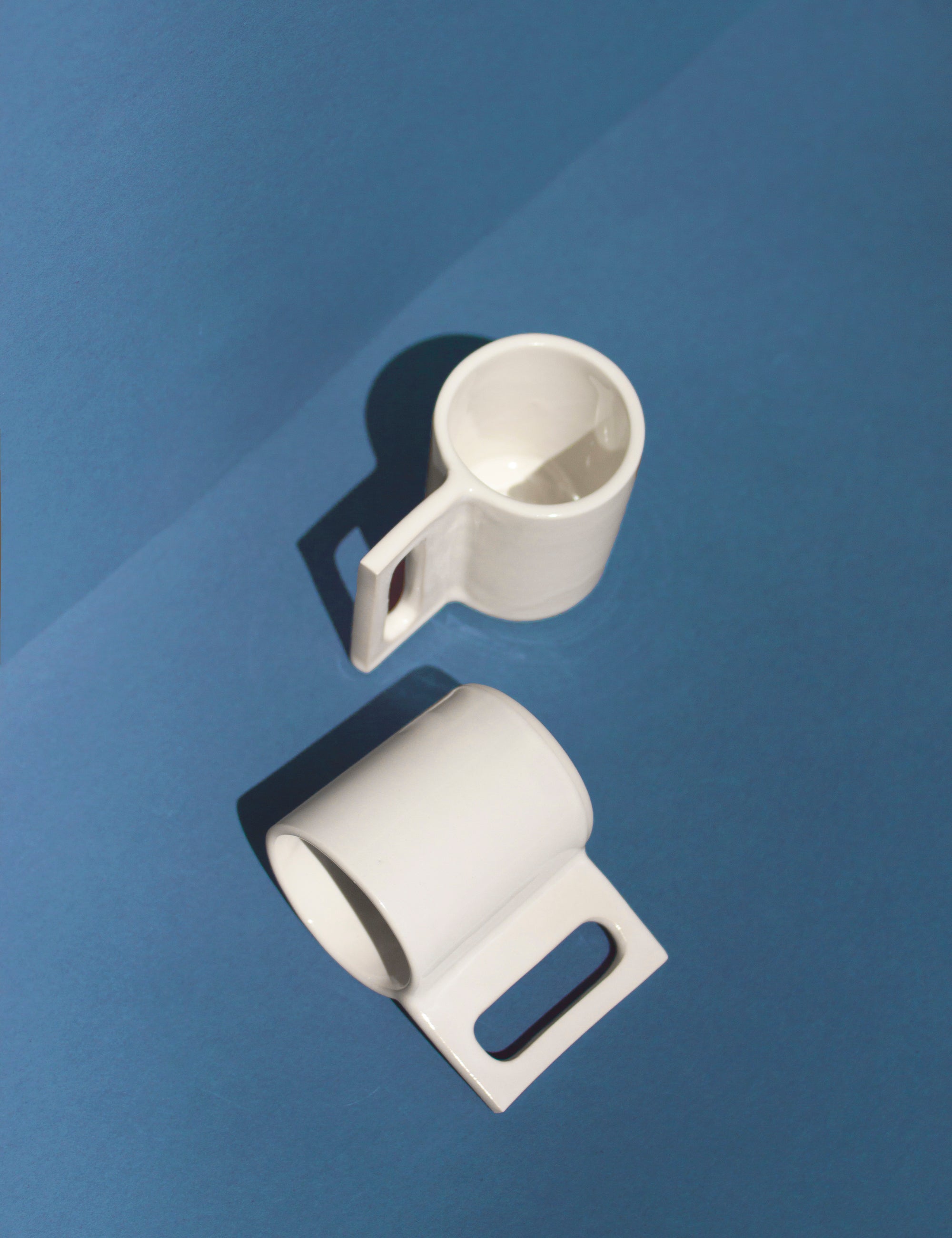 Handmade White mug with a geometric handle