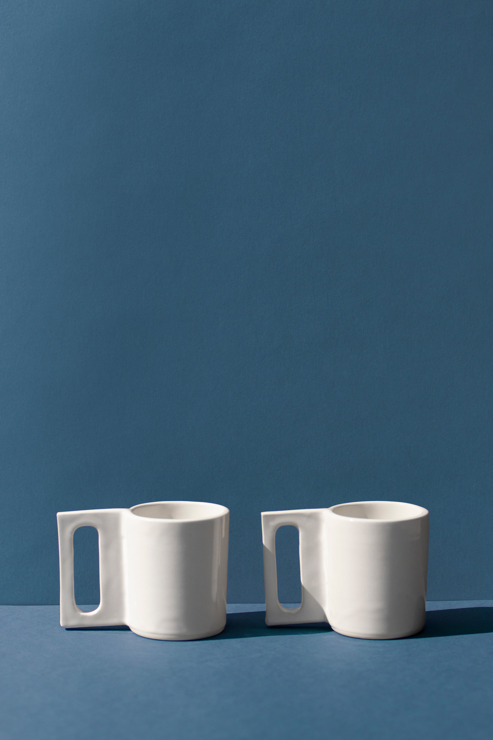 Handmade White mug with a geometric handle