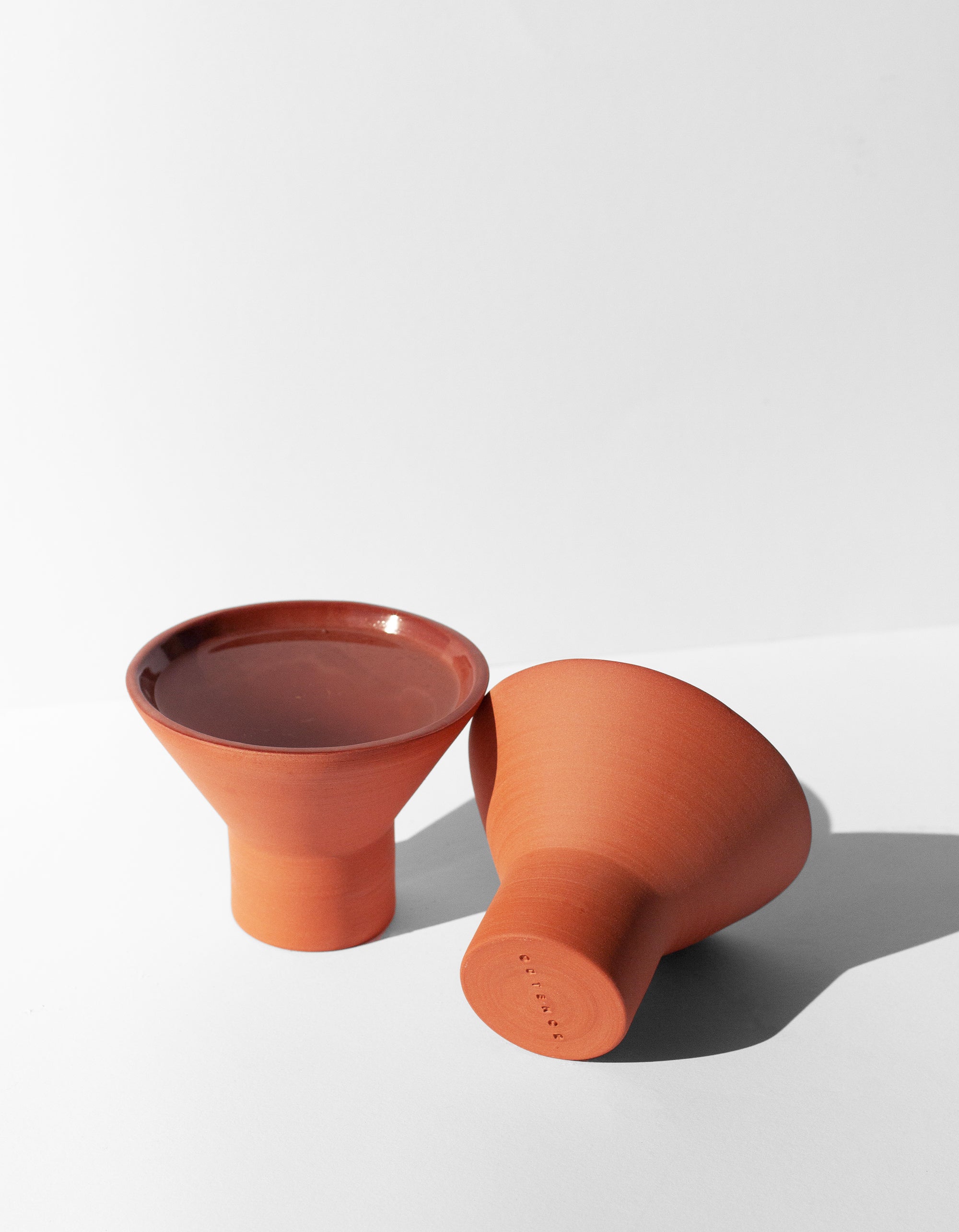 Handmade terra cotta cocktail glass with pedestal base and glossy glazed interior