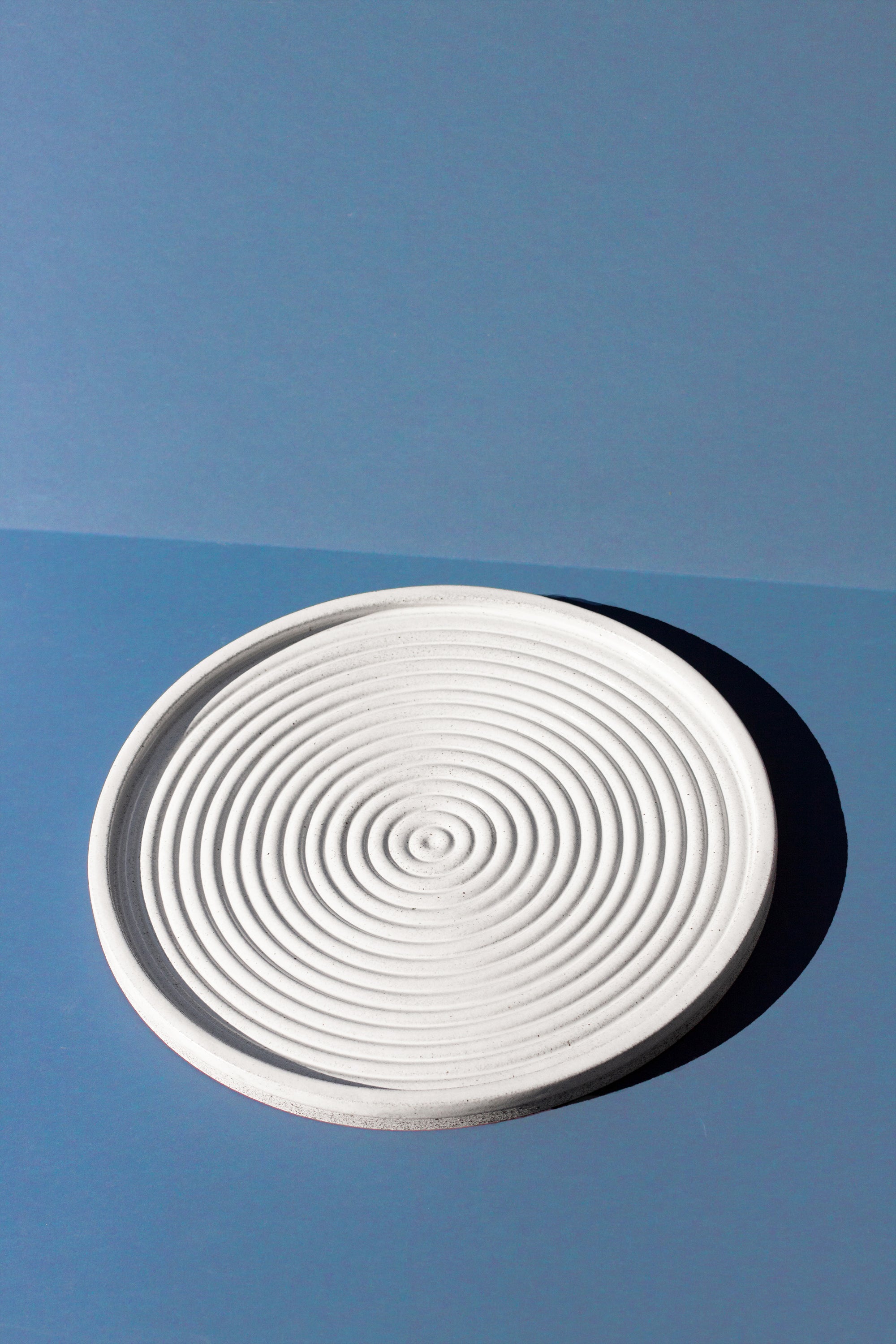 Handmade White serving platter with concentric circle design and speckled finish