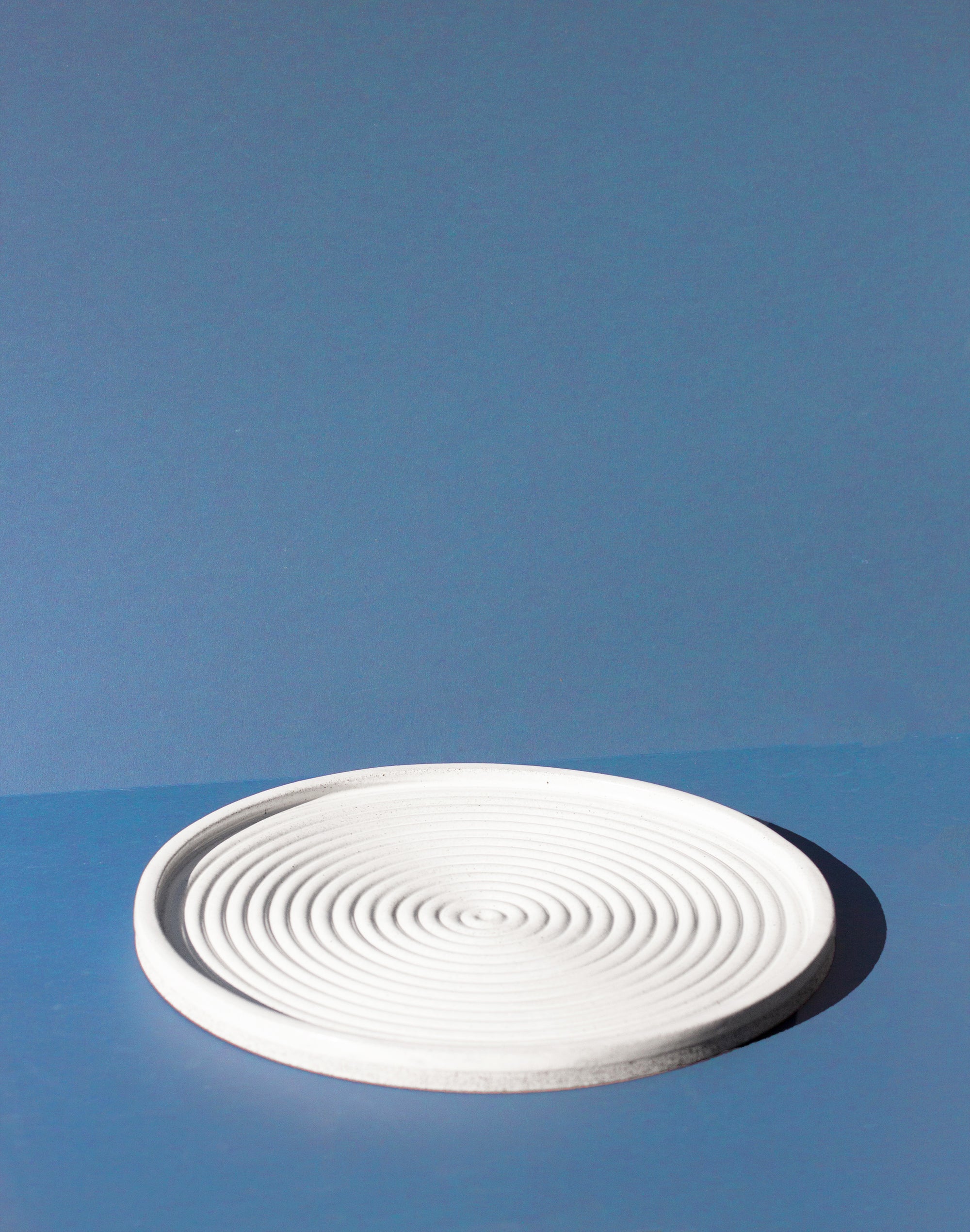 Handmade White serving platter with concentric circle design and speckled finish