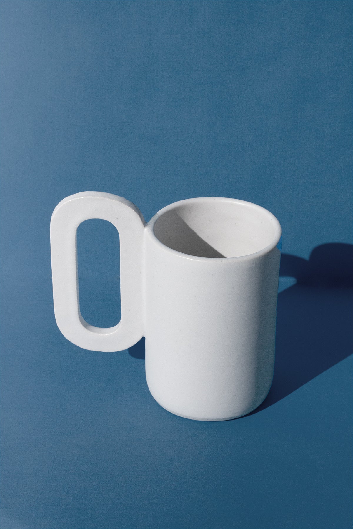 Handmade Tall white mug with loop shaped handle
