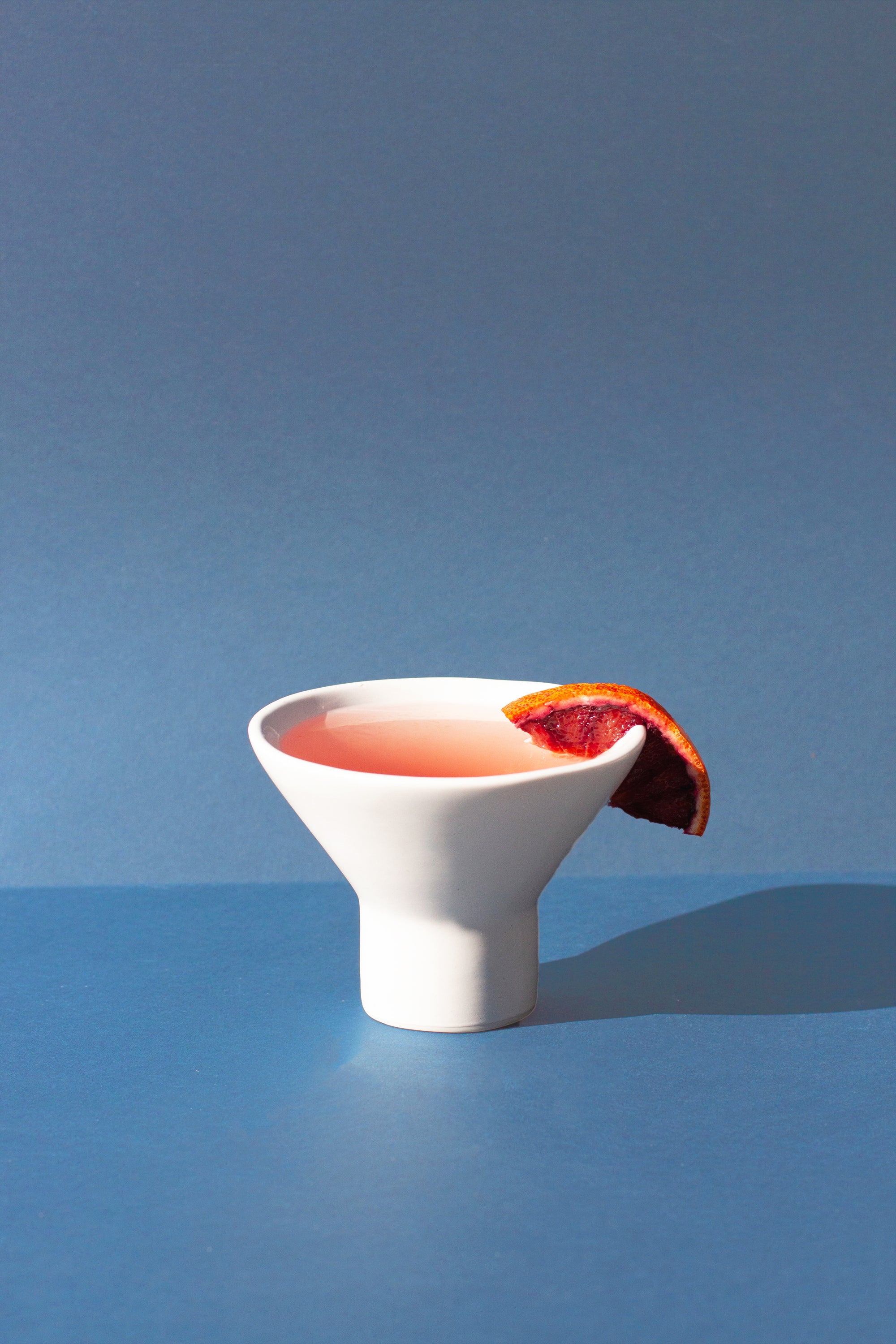 Handmade white cocktail glass with stemless pedestal base 